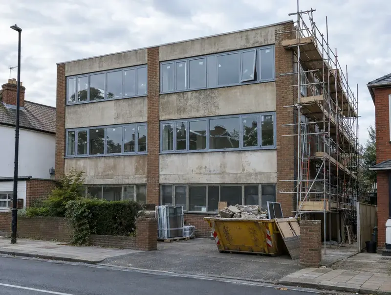 1970s office building being converted into flats, with scaffolding and new windows